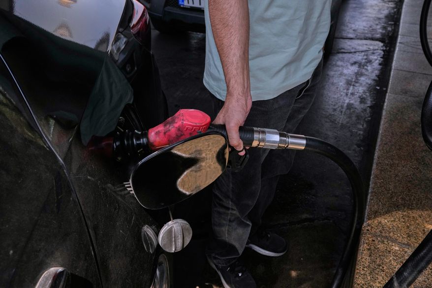 A man is filling up his car at a gas station in Tehran, Iran, Tuesday, Aug. 25, 2026. (AP Photo/Vahid Salemi)