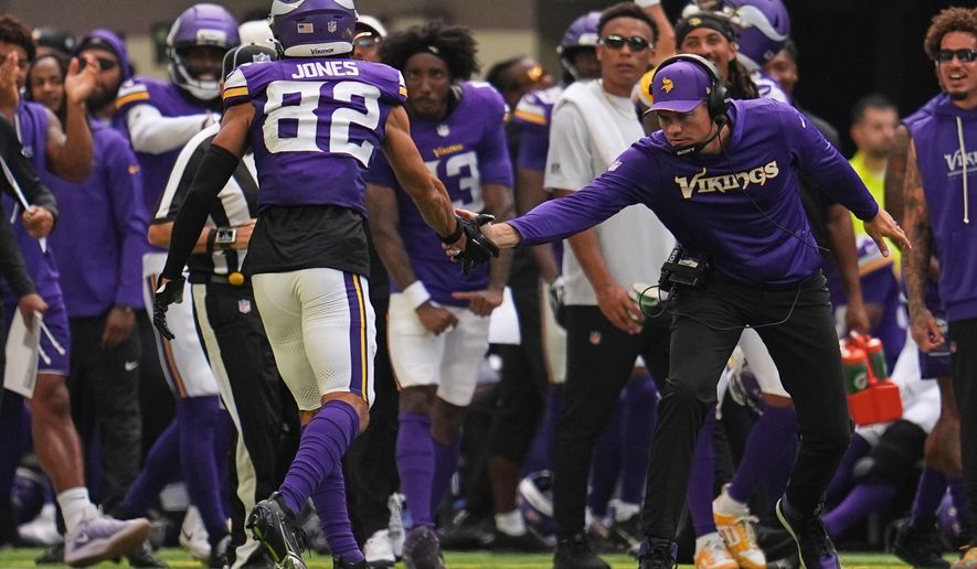 Minnesota Vikings wide receiver Jeshaun Jones (82) celebrates with head coach Kevin O'Connell after completing a 35-yard catch during the first half of an NFL preseason football game against the Baltimore Ravens, Saturday, Aug. 22, 2026, in Minneapolis. (AP Photo/Abbie Parr)