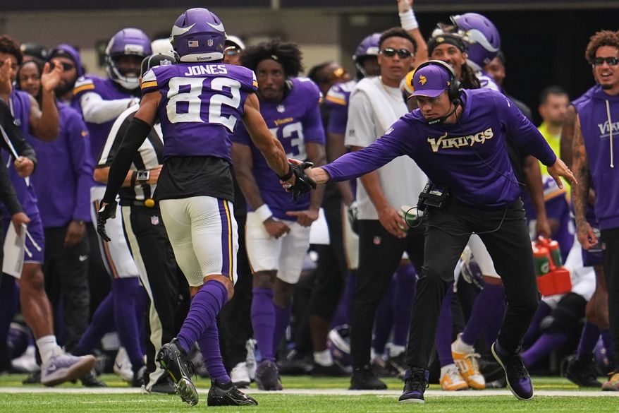 Minnesota Vikings wide receiver Jeshaun Jones (82) celebrates with head coach Kevin O'Connell after completing a 35-yard catch during the first half of an NFL preseason football game against the Baltimore Ravens, Saturday, Aug. 22, 2026, in Minneapolis. (AP Photo/Abbie Parr)