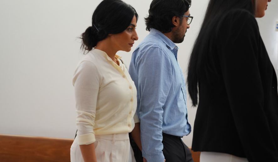 Nausheen Gilkar, left, and her husband Omar Ahmed arrive for a court hearing in Dallas, Tuesday, Aug. 25, 2026. (AP Photo/LM Otero)