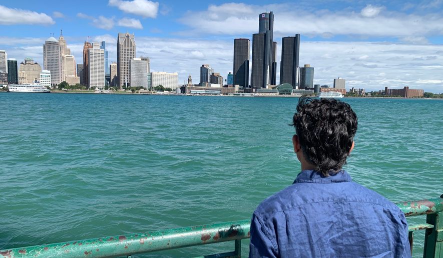 City Councillor Renaldo Agostino looks at the Detroit skyline across the Detroit River Monday, Aug. 24, 2026, in Windsor, Ontario (AP Photo/Mike Householder)