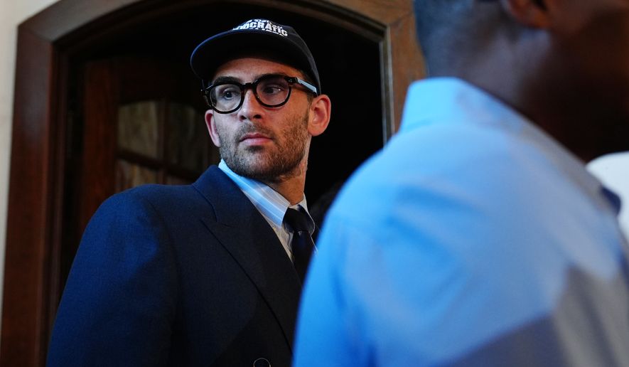 Streamer Hasan Pike listens as Abdul El-Sayed, a progressive candidate in the Democratic primary for U.S. Senate in Michigan, speaks at a campaign rally, Monday, Aug. 3, 2026, in Detroit. (AP Photo/Julia Demaree Nikhinson)