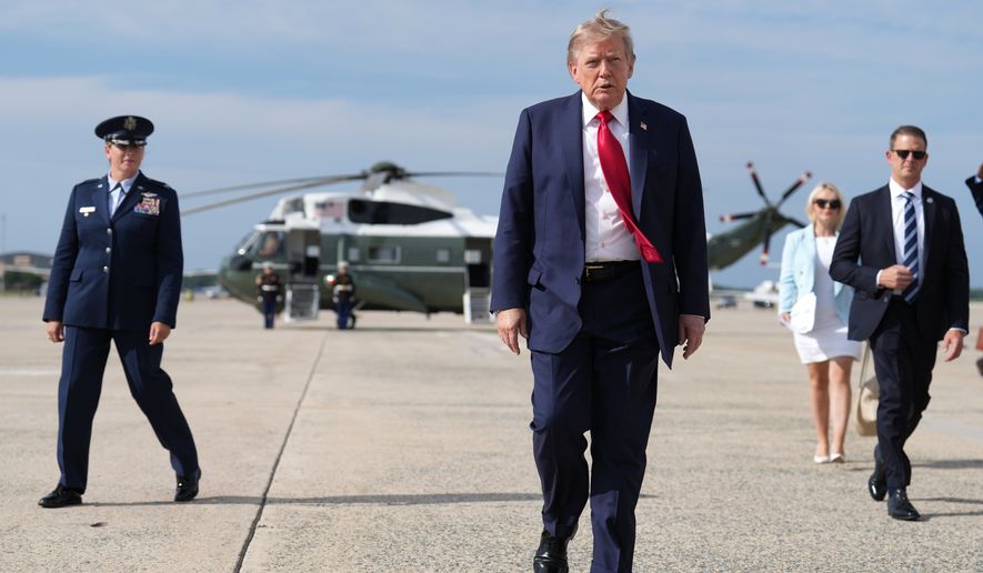 President Donald Trump, center, walks from Marine One to board Air Force One at Joint Base Andrews, Md., en route to South Carolina on Aug. 21, 2026. (AP Photo/Jacquelyn Martin) **FILE**