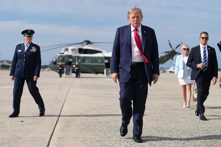 President Donald Trump, center, walks from Marine One to board Air Force One at Joint Base Andrews, Md., en route to South Carolina on Aug. 21, 2026. (AP Photo/Jacquelyn Martin) **FILE**