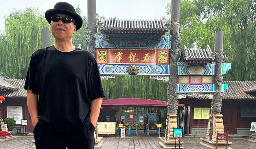 In this photo taken June 2023 and released by Zhao Yaliang, Chinese artist Gao Zhen poses for a photo in Jinan in northern China's Shandong province. (Zhao Yaliang via AP)