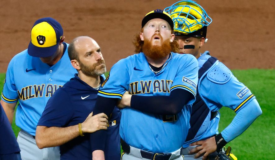 Milwaukee Brewers pitcher Dustin May reacts after being hit by a batted ball during the first inning of a baseball game against the New York Mets, Wednesday, Aug. 26, 2026, in New York. (AP Photo/Noah K. Murray)