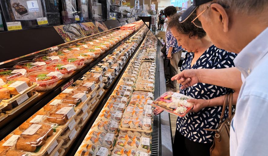 Customer shop at a grocery store in Arlington Heights, Ill., Monday, July 6, 2026. (AP Photo/Nam Y. Huh)
