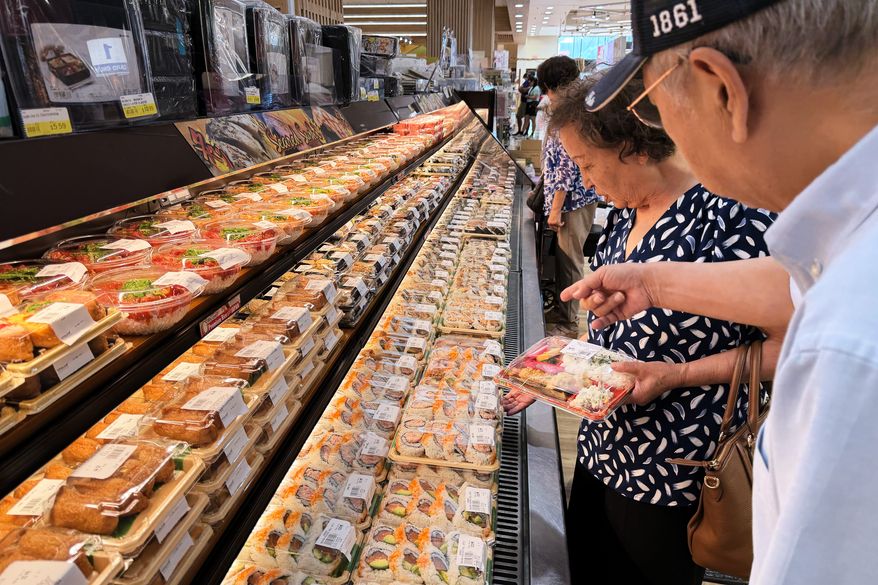 Customer shop at a grocery store in Arlington Heights, Ill., Monday, July 6, 2026. (AP Photo/Nam Y. Huh)