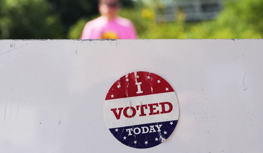 An "I Voted Today" sticker on an information sign at Olbrich Gardens Tuesday, Aug. 11, 2026, in Madison, Wis. (AP Photo/Nam Y. Huh)
