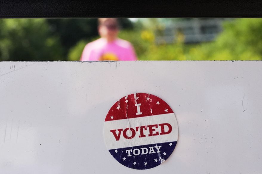An "I Voted Today" sticker on an information sign at Olbrich Gardens Tuesday, Aug. 11, 2026, in Madison, Wis. (AP Photo/Nam Y. Huh)