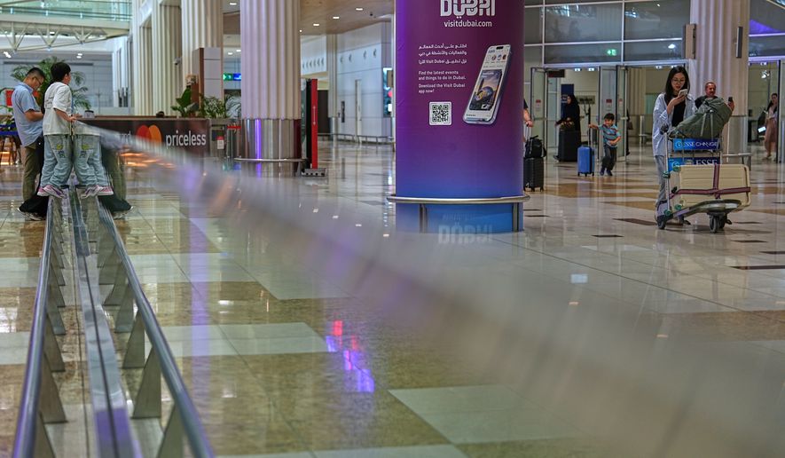 Passengers leave the baggage claim hall at Terminal 3 of Dubai International Airport in Dubai, United Arab Emirates, Wednesday, Aug. 26, 2026. (AP Photo/ Fatima Shbair)