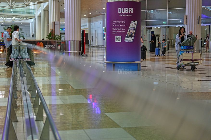 Passengers leave the baggage claim hall at Terminal 3 of Dubai International Airport in Dubai, United Arab Emirates, Wednesday, Aug. 26, 2026. (AP Photo/ Fatima Shbair)