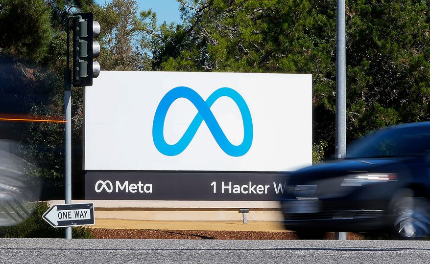 A car passes Facebook's new Meta logo on a sign at the company headquarters in Menlo Park, Calif., on Oct. 28, 2021. (AP Photo/Tony Avelar) **FILE**