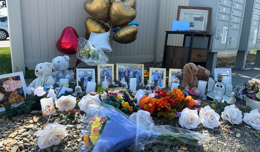 Flowers sit at a memorial honoring eight family members who were killed while gathering for dinner near the family home outside Billings, Mont., Wednesday, Aug. 26, 2026. (AP Photo/Matthew Brown)