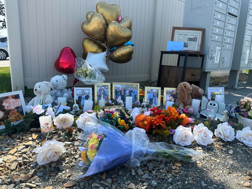 Flowers sit at a memorial honoring eight family members who were killed while gathering for dinner near the family home outside Billings, Mont., Wednesday, Aug. 26, 2026. (AP Photo/Matthew Brown)