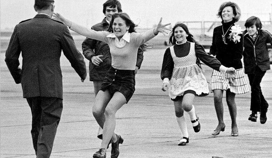 FILE - Released prisoner of war Lt. Col. Robert L. Stirm is greeted by his family at Travis Air Force Base in Fairfield, Calif., as he returns home from the Vietnam War, March 17, 1973. (AP Photo/Sal Veder, File)