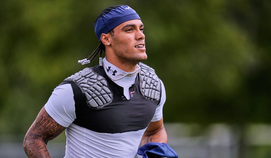 New England Patriots cornerback Christian Gonzalez runs towards a practice field during the team's NFL football training camp, Tuesday, Aug. 25, 2026, in Foxborough, Mass. (AP Photo/Charles Krupa)