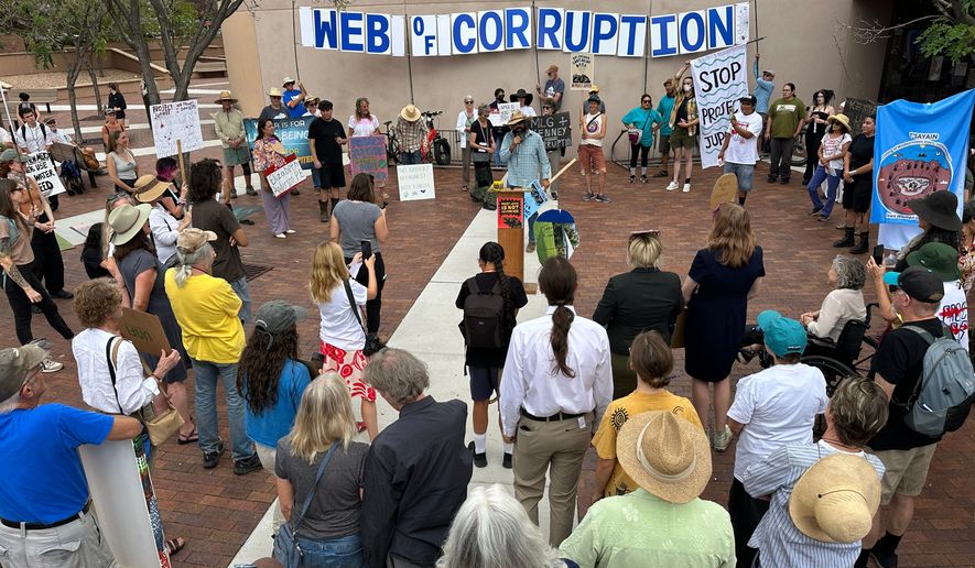 Protesters gather outside the New Mexico Environment Department to voice opposition to the Project Jupiter data center during a demonstration in Santa Fe, N.M., Friday, Aug. 21, 2026. (AP Photo/Susan Montoya Bryan)