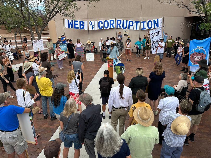 Protesters gather outside the New Mexico Environment Department to voice opposition to the Project Jupiter data center during a demonstration in Santa Fe, N.M., Friday, Aug. 21, 2026. (AP Photo/Susan Montoya Bryan)