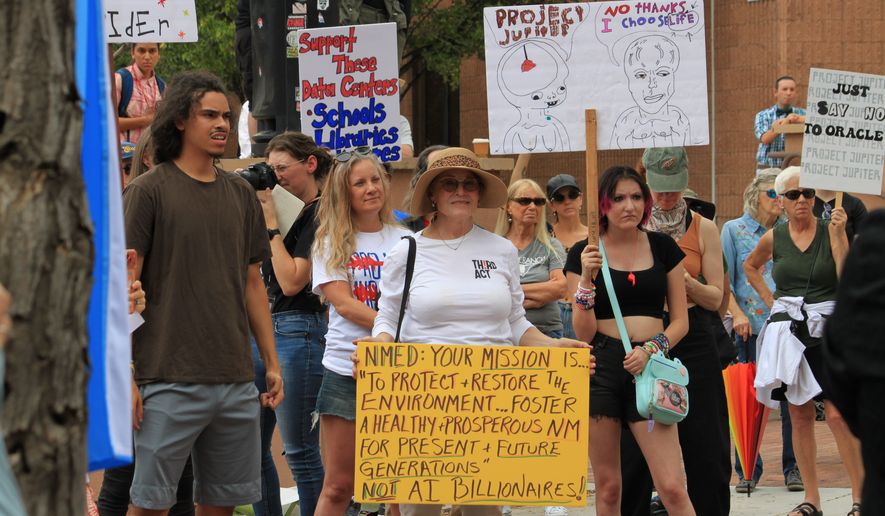 Protesters gather outside a state office to voice opposition to the Project Jupiter data center during a demonstration in Santa Fe, N.M., Friday, Aug. 21, 2026. (AP Photo/Susan Montoya Bryan)
