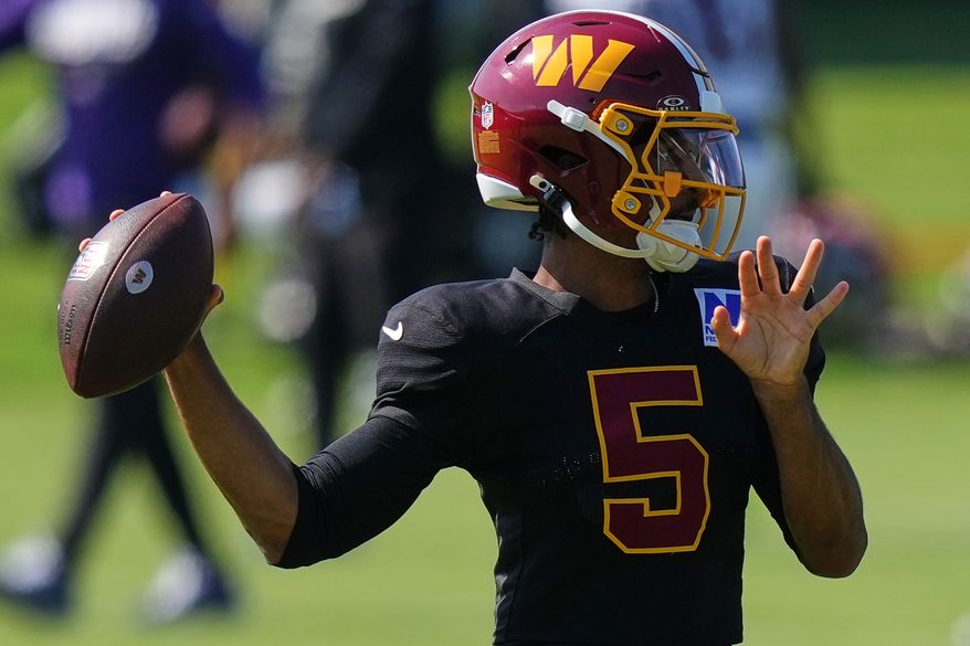Washington Commanders quarterback Jayden Daniels (5) works out during the team's NFL football joint training camp with the Baltimore Ravens, Wednesday, Aug. 26, 2026, at the Under Armour Performance Center in Owings Mills, Md. (AP Photo/Stephanie Scarbrough)