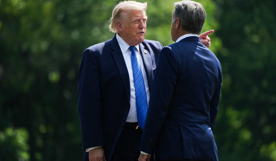 President Donald Trump, left, and CIA Director John Ratcliffe speak as they depart following a cabinet meeting at Camp David, near Thurmont, Md., Friday, July 31, 2026. (Nathan Howard/Pool Photo via AP)