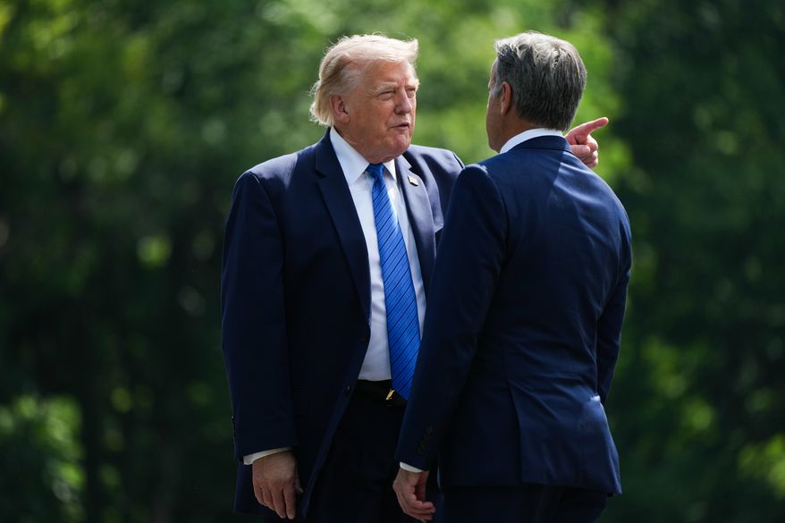 President Donald Trump, left, and CIA Director John Ratcliffe speak as they depart following a cabinet meeting at Camp David, near Thurmont, Md., Friday, July 31, 2026. (Nathan Howard/Pool Photo via AP)
