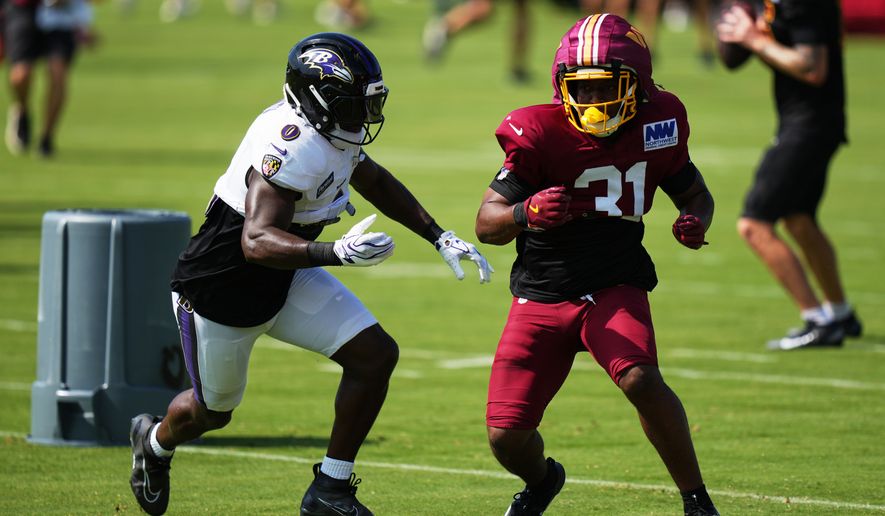 Baltimore Ravens linebacker Roquan Smith (0) and Washington Commanders cornerback Rasul Douglas (31) work out during the teams' NFL football joint training camp, Wednesday, Aug. 26, 2026, at the Under Armour Performance Center in Owings Mills, Md. (AP Photo/Stephanie Scarbrough)