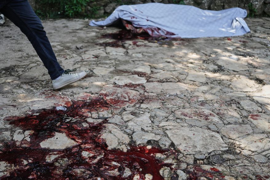 Blood stains the ground left behind by the victim of a gang attack in the Kenscoff neighborhood of Port-au-Prince, Haiti, Monday, Aug. 24, 2026. (AP Photo/Odelyn Joseph)