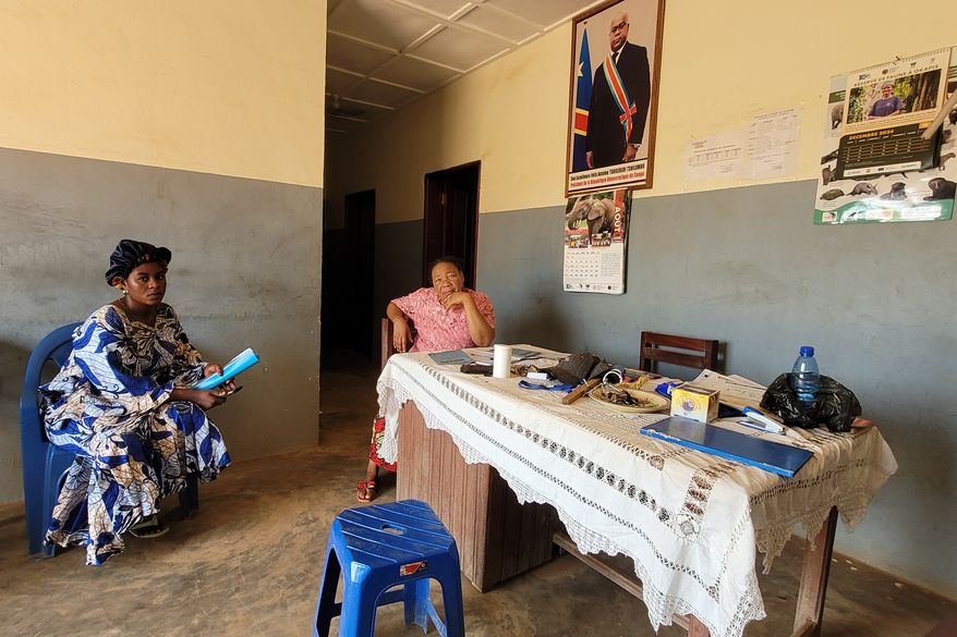 Parents who came for their children's school resumption sit inside an office of a school in Ituri province, eastern Congo, Thursday, Aug. 27, 2026. (AP Photo/Constant Same Bagalwa)