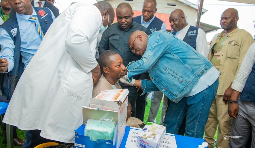 Congo’s Health Minister Roger Kamba administers an Ebola vaccine to a health care worker in Kisangani, Congo, Thursday, Aug. 27, 2026. (AP Photo/Samy Kamanga)
