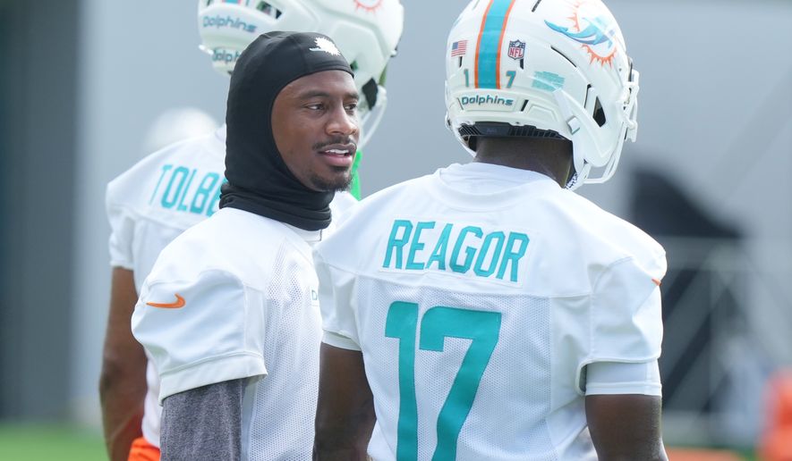 Miami Dolphins wide receiver Tutu Atwell, left, talks to wide receiver Jalen Reagor (17) during practice at the team's NFL football training camp, Friday, July 31, 2026, in Miami Gardens, Fla. (AP Photo/Marta Lavandier)