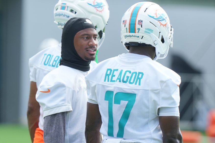 Miami Dolphins wide receiver Tutu Atwell, left, talks to wide receiver Jalen Reagor (17) during practice at the team's NFL football training camp, Friday, July 31, 2026, in Miami Gardens, Fla. (AP Photo/Marta Lavandier)