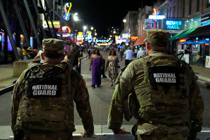 FILE - Members of the National Guard stand watch on Beale St., Friday, July 17, 2026, in Memphis, Tenn. (AP Photo/George Walker IV,File)
