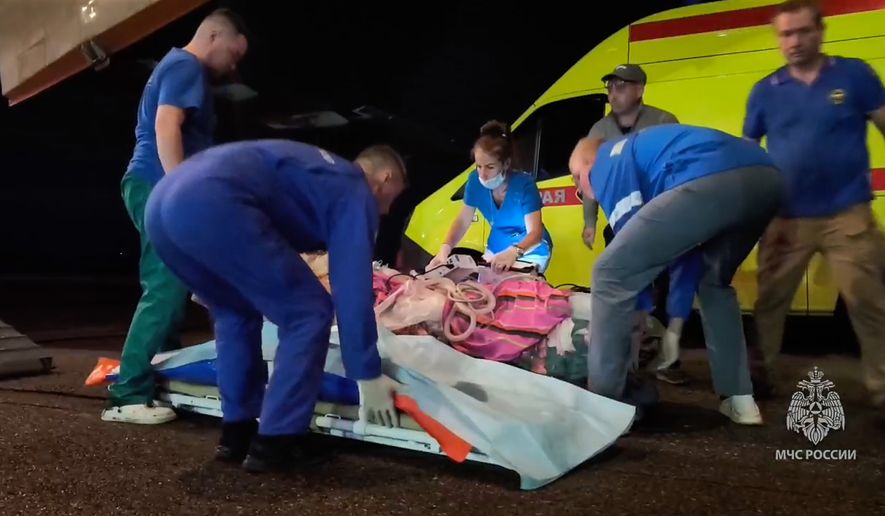 In this image made from video provided by Russian Emergency Situations Ministry press service, medical and rescue workers put those injured in a fire at the Amur Gas Chemical Complex on a plane to Moscow in Blagoveschensk, Amur region, Russia, Thursday, Aug. 27, 2026. (Ministry of Emergency Situations press service via AP)