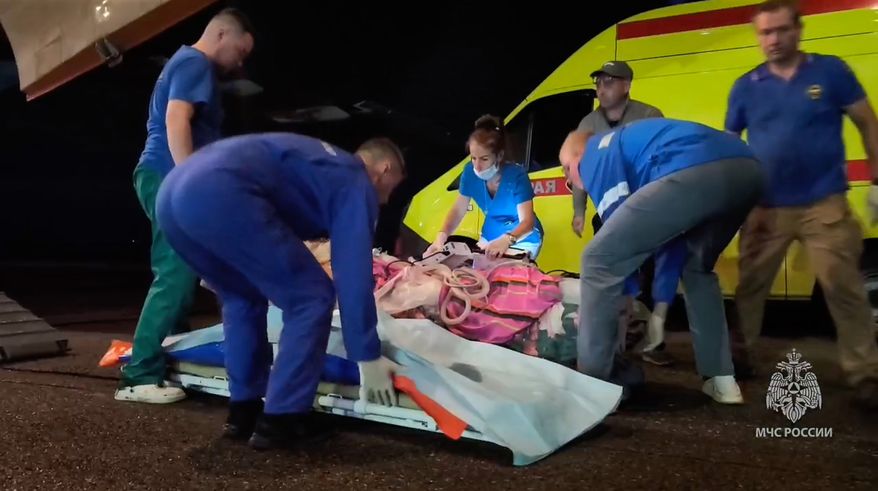 In this image made from video provided by Russian Emergency Situations Ministry press service, medical and rescue workers put those injured in a fire at the Amur Gas Chemical Complex on a plane to Moscow in Blagoveschensk, Amur region, Russia, Thursday, Aug. 27, 2026. (Ministry of Emergency Situations press service via AP)