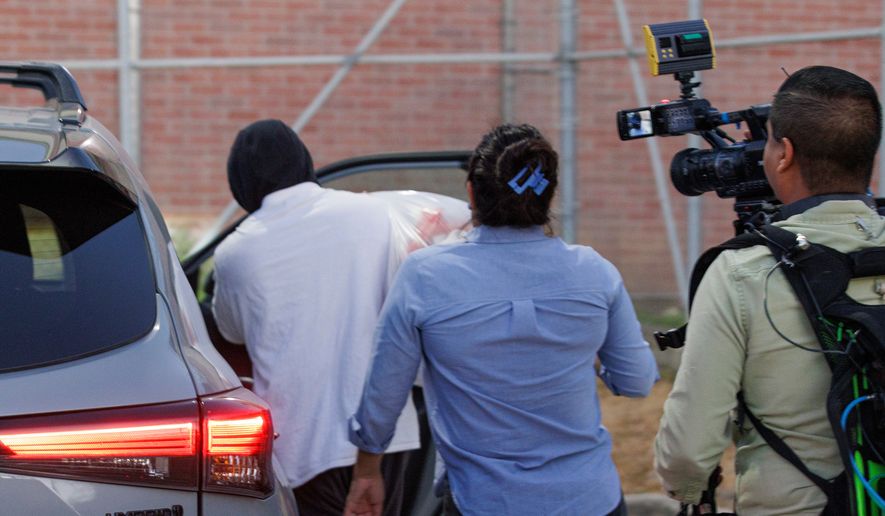 Immigration and Customs Enforcement Officer Christian Castro gets into a car surrounded by news reporters moments after being released from the Carrizalez-Rucker Cameron County Detention Center in Brownsville, Texas, on Thursday, Aug. 27, 2026. (AP Photo/Michael Gonzalez)