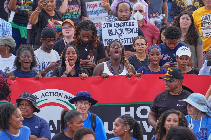 Demonstrators shout to speakers during the March on Washington, near the Lincoln Memorial, Friday, Aug. 28, 2026, in Washington. (AP Photo/Mariam Zuhaib)