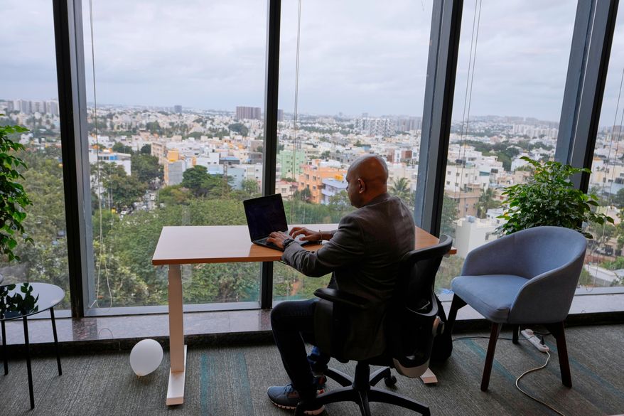 Shivaram K R, CEO of Hue Learn, works in his office with the city's skyline in the background, in Bengaluru, India, Monday, Aug. 24, 2026. (AP Photo/Aijaz Rahi)