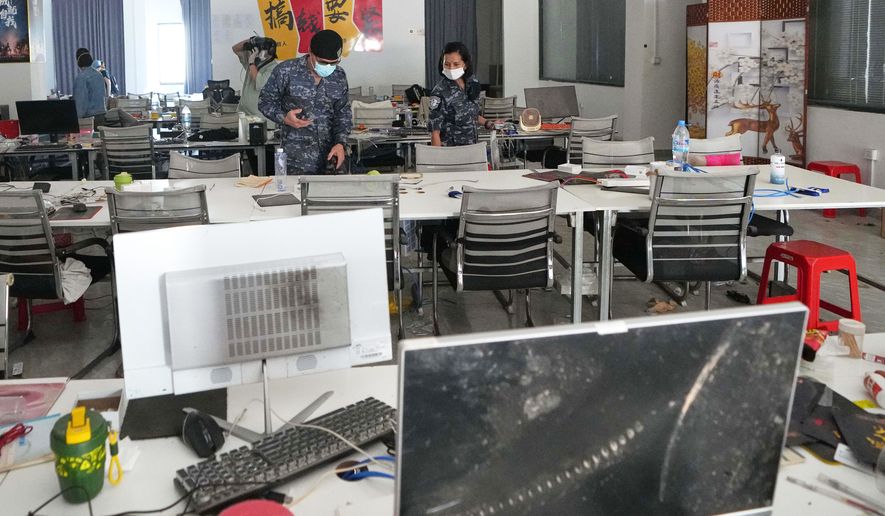 FILE - Thai soldiers inspect a work station at the scam compound in O'Smach, Cambodia, April 7, 2026. (AP Photo/Sakchai Lalit, File)