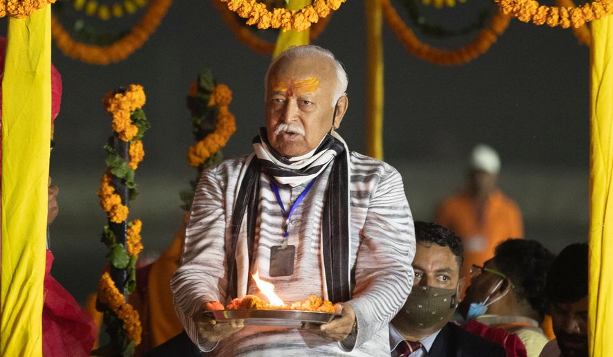 Hindu nationalist Rashtriya Swayamsevak Sangh (RSS) chief Mohan Bhagwat offers prayers at Sangam, the confluence of the rivers Ganges and the Yamuna and mythical Saraswati rivers, at the annual traditional fair of Magh Mela in Prayagraj, India, Friday, Feb. 19, 2021. (AP Photo/Rajesh Kumar Singh, File)