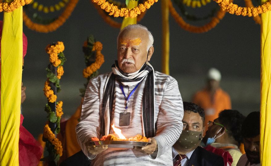 Hindu nationalist Rashtriya Swayamsevak Sangh (RSS) chief Mohan Bhagwat offers prayers at Sangam, the confluence of the rivers Ganges and the Yamuna and mythical Saraswati rivers, at the annual traditional fair of Magh Mela in Prayagraj, India, Friday, Feb. 19, 2021. (AP Photo/Rajesh Kumar Singh, File)