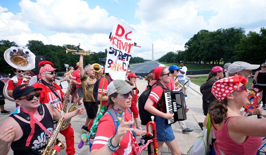 A group of local activist from Washington DC, demonstrating during the March on Washington rally at the Lincoln Memorial on the National Mall, Friday, Aug. 28, 2026 in Washington. (AP Photo/Manuel Balce Ceneta)
