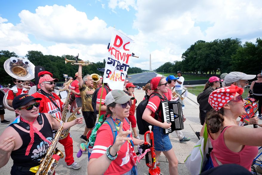 A group of local activist from Washington DC, demonstrating during the March on Washington rally at the Lincoln Memorial on the National Mall, Friday, Aug. 28, 2026 in Washington. (AP Photo/Manuel Balce Ceneta)