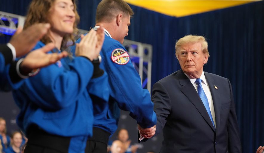 President Donald Trump, from right, shakes the hand of Artemis II crew member Jeremy Hansen after presenting him the Congressional Space Medal of Honor as fellow recipient Christina Koch applauds, Friday, Aug. 28, 2026, at Johnson Space Center in Houston. (AP Photo/Mark Schiefelbein)