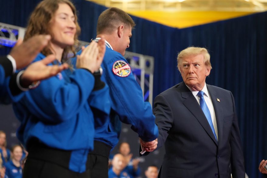 President Donald Trump, from right, shakes the hand of Artemis II crew member Jeremy Hansen after presenting him the Congressional Space Medal of Honor as fellow recipient Christina Koch applauds, Friday, Aug. 28, 2026, at Johnson Space Center in Houston. (AP Photo/Mark Schiefelbein)