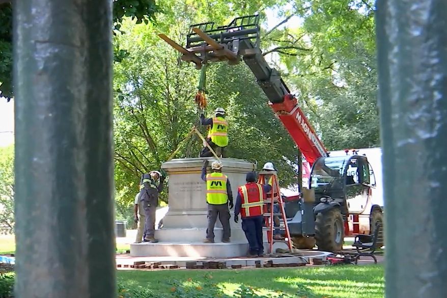 This image taken from a WRIC video shows workers attaching straps to a Confederate statue as they prepare to remove it from Capitol Square in Richmond, Va., on Friday, Aug. 28, 2026. (Courtesy WRIC)
