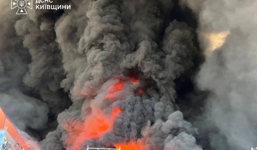 In this photo provided by the Ukrainian Emergency Service, firefighters put out a fire in a warehouse following a Russian drone attack near Kyiv, Ukraine, Saturday, Aug. 29, 2026. (Ukrainian Emergency Service via AP)