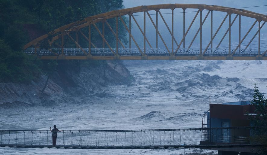 A resident looks at the swollen Trishuli river in Galchhi, Dhading District, Nepal, Sunday, Aug. 30, 2026. (AP Photo/Niranjan Shrestha)