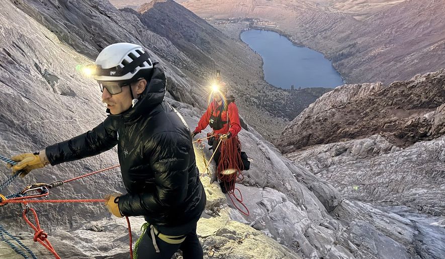 This photo released by the Mono County Search and Rescue shows volunteers conducting an operation to rescue a man stranded on a ledge in the Sierra Nevada, Calif., on Aug. 22, 2026. (Mono County Sheriff Search and Rescue via AP)